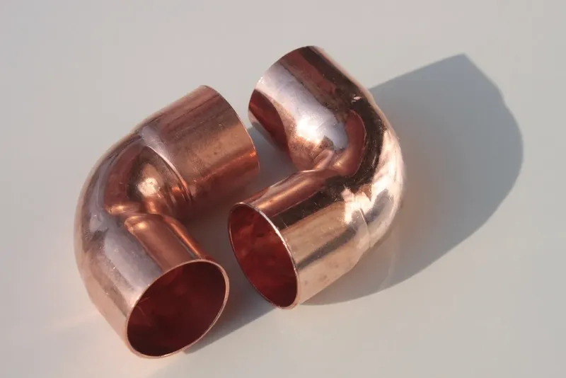 Two copper elbow fittings