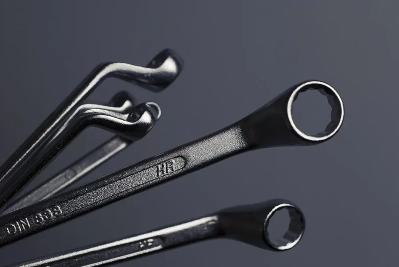 Combination wrenches on a dark surface